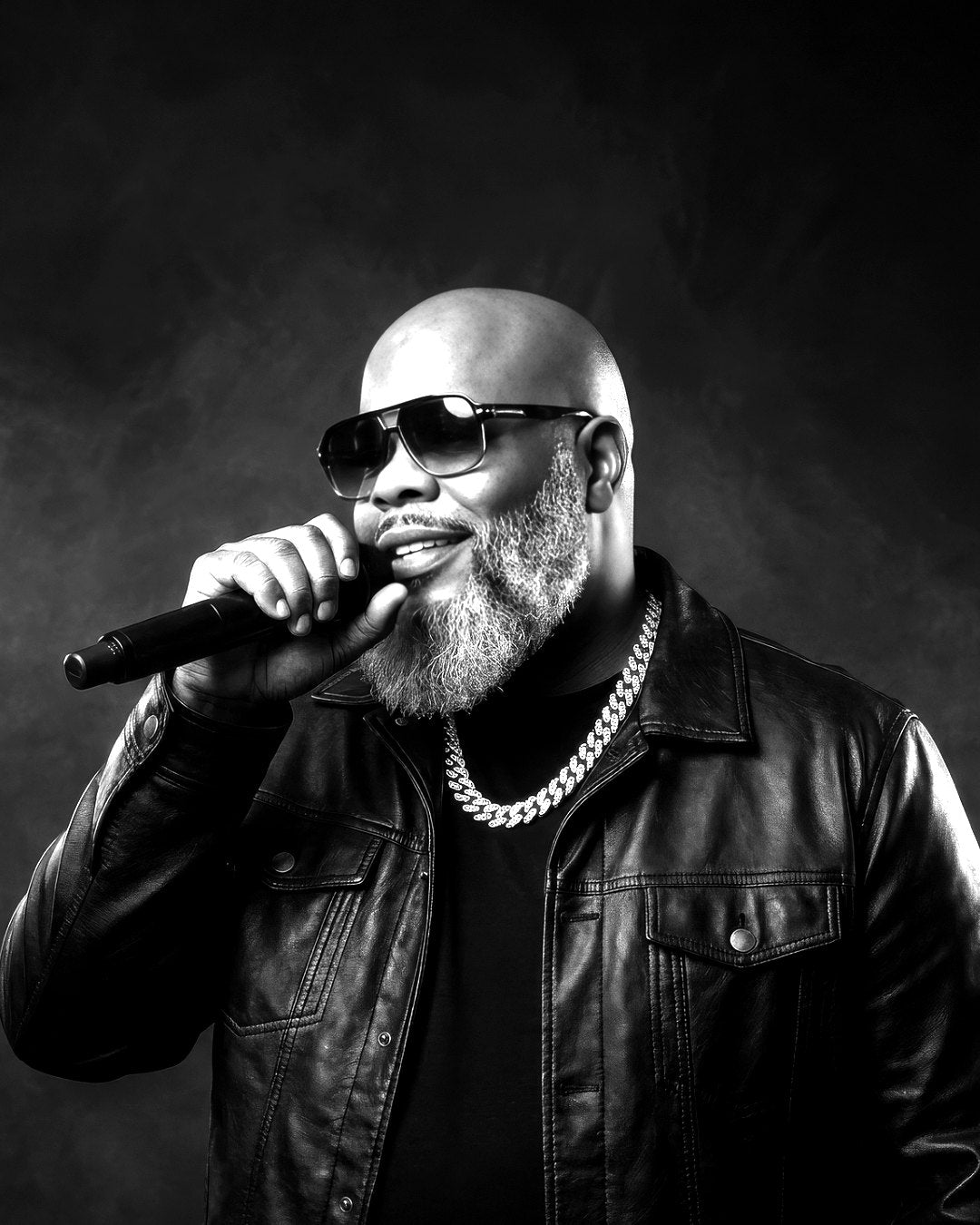 Black and white photo of Tom Swoope singing into a microphone
